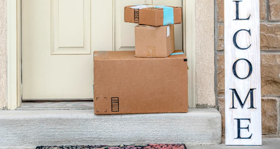 Boxes by the door of a residence with a welcome sign in Pittsburgh